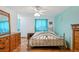 This bedroom features light colored walls, hardwood floors, and a metal frame bed at 7761 Everett Way, Arvada, CO 80005