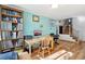 Home office area featuring hardwood floors, built-in bookshelves, and a functional workspace at 7761 Everett Way, Arvada, CO 80005