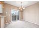 Spacious dining area with chandelier and sliding glass door at 6837 S Webster St # C, Littleton, CO 80128