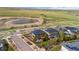 Aerial view of homes with solar panels, green spaces, and scenic pond with a view of the neighborhood at 9570 Kendrick Way, Arvada, CO 80007