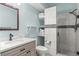 Stylish bathroom featuring a shower and a vanity with quartz countertop at 9570 Kendrick Way, Arvada, CO 80007