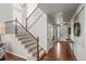 Welcoming entryway features dark wood floors and a staircase with decorative metalwork at 9570 Kendrick Way, Arvada, CO 80007