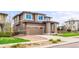 Inviting two-story home boasting an attached two-car garage, brick accents, and a well-kept lawn at 9570 Kendrick Way, Arvada, CO 80007