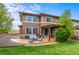 A home with a backyard patio, beautiful landscaping, and a wooden privacy fence, providing a serene outdoor experience at 9570 Kendrick Way, Arvada, CO 80007