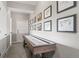 Hallway featuring a stylish shuffleboard table and decorative golf course artwork at 9570 Kendrick Way, Arvada, CO 80007