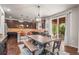 Inviting kitchen features dark wood cabinets, granite countertops, and flows seamlessly into dining area with access to patio at 9570 Kendrick Way, Arvada, CO 80007