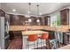 Spacious kitchen boasts stainless steel appliances, granite countertops, and a center island with bar seating at 9570 Kendrick Way, Arvada, CO 80007