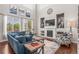 Bright living room featuring large windows, high ceilings, a fireplace, and comfortable seating, creating an inviting atmosphere at 9570 Kendrick Way, Arvada, CO 80007