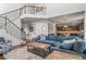 Spacious living room boasts an open floor plan, staircase, and flows into kitchen, perfect for entertaining at 9570 Kendrick Way, Arvada, CO 80007