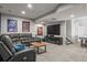 Spacious living room with a comfortable sectional couch and large television at 9570 Kendrick Way, Arvada, CO 80007