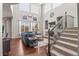 Cozy living room featuring dark wood floors, high ceilings, and a staircase with decorative metalwork at 9570 Kendrick Way, Arvada, CO 80007