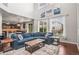 Bright, open living room features a large blue sectional, hardwood floors, and plenty of natural light at 9570 Kendrick Way, Arvada, CO 80007
