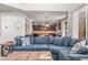 Comfortable living room featuring an open layout, large windows, and seamless transition to the kitchen at 9570 Kendrick Way, Arvada, CO 80007