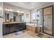 Spa-like main bathroom with dual sinks, soaking tub, and tiled walk-in shower at 9570 Kendrick Way, Arvada, CO 80007