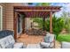 Inviting patio with a pergola, stone accents, and comfortable outdoor seating for relaxing and entertaining at 9570 Kendrick Way, Arvada, CO 80007