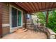 Outdoor patio featuring a pergola, a stone retaining wall, and a convenient sliding door access to the home at 9570 Kendrick Way, Arvada, CO 80007
