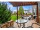 Charming covered patio area with cozy seating, perfect for enjoying the outdoor view of the landscaped yard at 9570 Kendrick Way, Arvada, CO 80007