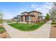 Neighborhood street showcasing well-maintained lawns and sidewalks, enhancing the community's curb appeal at 9570 Kendrick Way, Arvada, CO 80007