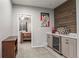 Finished basement with a bar area, cabinets, and a peek into another room at 9570 Kendrick Way, Arvada, CO 80007