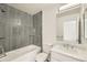 Stylish bathroom featuring a shower over tub with gray tiling and a sink with marble countertop at 400 Smith Cir, Erie, CO 80516