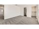 Bright bedroom with neutral walls and carpet, offering a view of an open closet at 400 Smith Cir, Erie, CO 80516