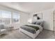 Comfortable bedroom with natural light, neutral carpet, and a relaxing chair at 400 Smith Cir, Erie, CO 80516