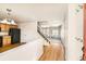 Bright foyer with hardwood floors, a staircase, and a view into the kitchen and living area at 400 Smith Cir, Erie, CO 80516