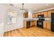 Kitchen with wooden cabinets, stainless steel appliances, hardwood floor and abundant natural light at 400 Smith Cir, Erie, CO 80516