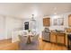Cozy kitchen area with a round table and chairs, stainless steel appliances and hardwood floors at 400 Smith Cir, Erie, CO 80516