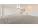 Spacious carpeted living area featuring bright lighting and stairs to the upper level at 400 Smith Cir, Erie, CO 80516