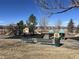 Community playground featuring slides, climbing structures, and swings for outdoor enjoyment at 400 Smith Cir, Erie, CO 80516