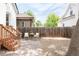 Charming backyard with stone patio, comfortable seating, and privacy fence creating a cozy outdoor space at 230 E Ellsworth Ave, Denver, CO 80209
