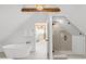 Clean and modern bathroom with soaking tub and glass-enclosed shower, open to the hallway at 230 E Ellsworth Ave, Denver, CO 80209