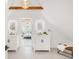 Modern bathroom with double vanities, illuminated mirrors, and a view into an adjacent bedroom at 230 E Ellsworth Ave, Denver, CO 80209