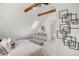 Cozy bedroom features vaulted ceilings, wooden beams, a skylight, and modern furnishings at 230 E Ellsworth Ave, Denver, CO 80209