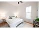 Bright bedroom with a comfortable bed, ample natural light, and minimalist decor at 230 E Ellsworth Ave, Denver, CO 80209