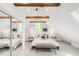 Comfortable bedroom with exposed wood beams, mirrors, and natural light from the window at 230 E Ellsworth Ave, Denver, CO 80209