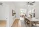 Bright dining room features light wood floors, modern lighting, and open access to the living room for easy entertaining at 230 E Ellsworth Ave, Denver, CO 80209