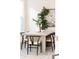 Elegant dining room showcasing a stylish table, woven chairs, and greenery, perfect for gatherings at 230 E Ellsworth Ave, Denver, CO 80209