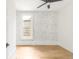Bright, airy room with hardwood floors, ceiling fan, and a large window, perfect for customization at 230 E Ellsworth Ave, Denver, CO 80209