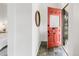 Charming foyer with slate tile floors and a bright orange front door at 230 E Ellsworth Ave, Denver, CO 80209