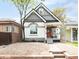 Charming two-story home showcasing a picturesque exterior with unique architectural details and landscaped front yard at 230 E Ellsworth Ave, Denver, CO 80209