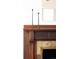 Detailed view of the fireplace with an ornamental wood mantle at 230 E Ellsworth Ave, Denver, CO 80209