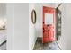 Bright foyer with slate tile flooring and a vibrant orange door, leading into a beautifully designed home at 230 E Ellsworth Ave, Denver, CO 80209