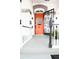 Inviting front porch and orange door featuring a wrought iron security door and white railings at 230 E Ellsworth Ave, Denver, CO 80209