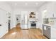 Bright kitchen featuring stainless steel appliances, white cabinets, and butcher block shelving at 230 E Ellsworth Ave, Denver, CO 80209