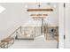 Bright living room with white walls, wood beam design, modern light fixture, and comfortable seating area at 230 E Ellsworth Ave, Denver, CO 80209