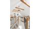 Stylish living room with exposed beams, modern lighting, and comfortable seating accessible by wooden staircase at 230 E Ellsworth Ave, Denver, CO 80209