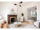 Bright living room with modern lighting, fireplace, and an open doorway to the dining room at 230 E Ellsworth Ave, Denver, CO 80209