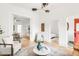 Spacious living room with an open floor plan connecting to the dining area and bedroom at 230 E Ellsworth Ave, Denver, CO 80209